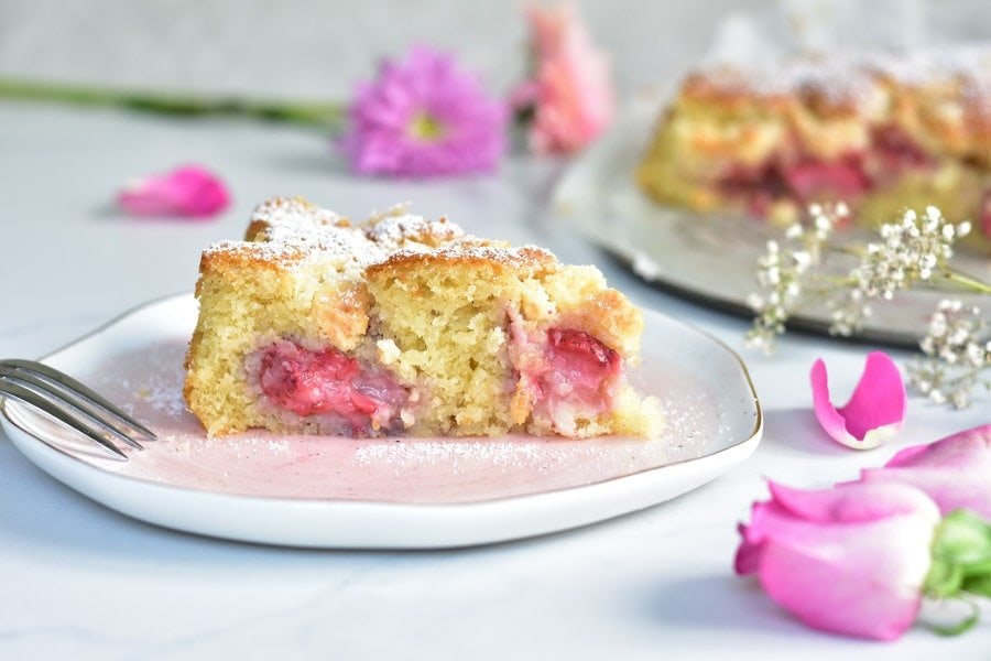 a piece of strawberry coconut cake on a rose plate