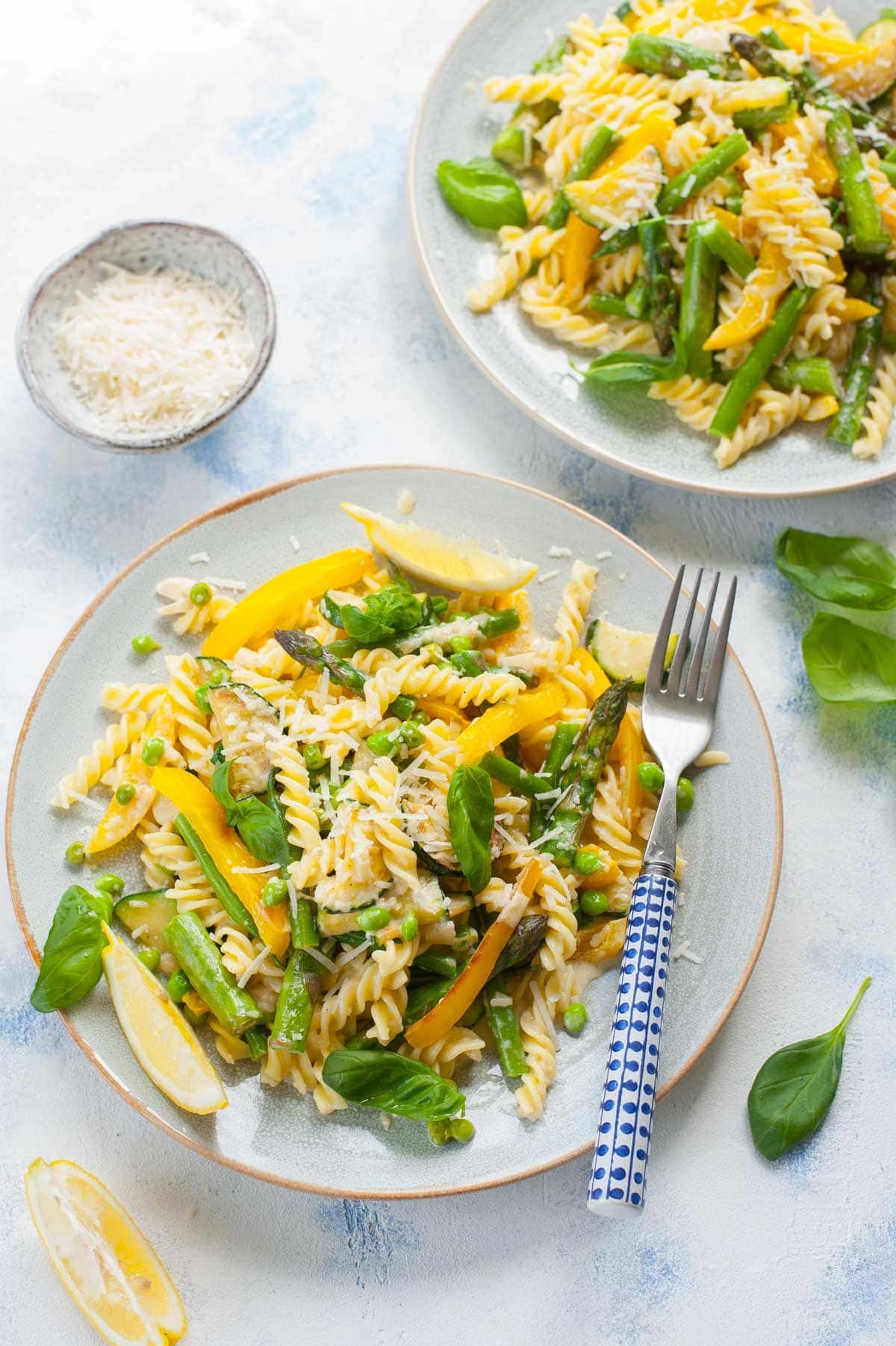 Pasta primavera on a blue plate.