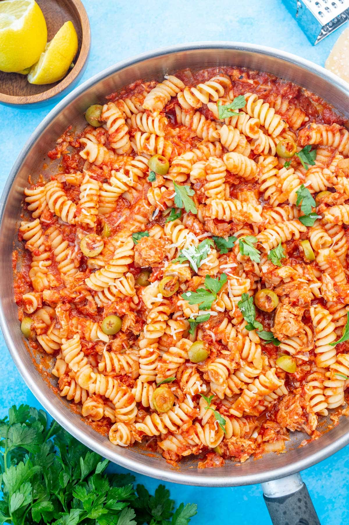 Tuna pasta with tomatoes and olives in a large frying pan.